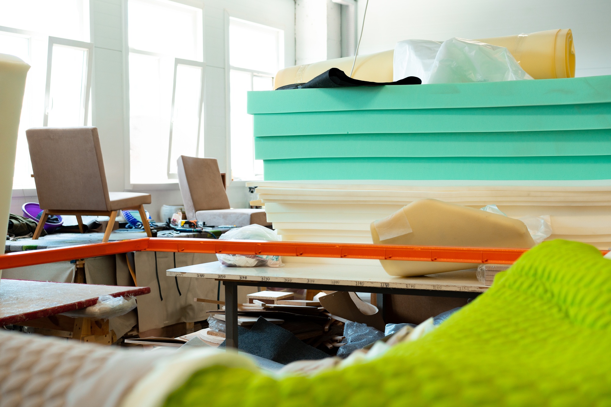 Stacked sheets of foam rubber for furniture production in factory workshop